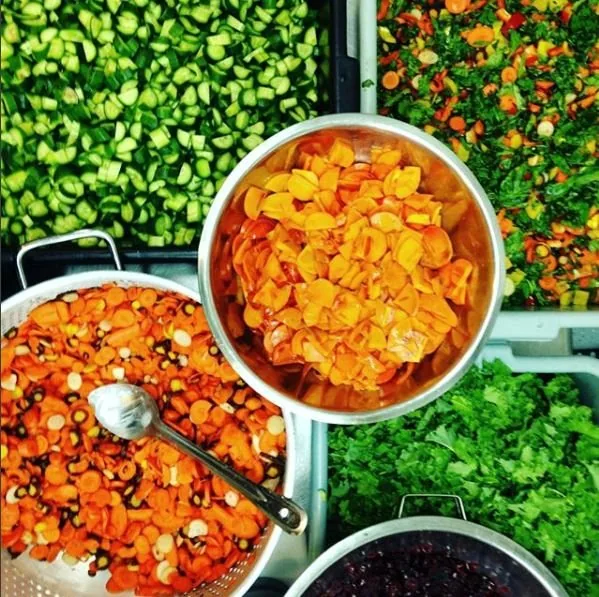 Trays of freshly chopped vegetables and greens