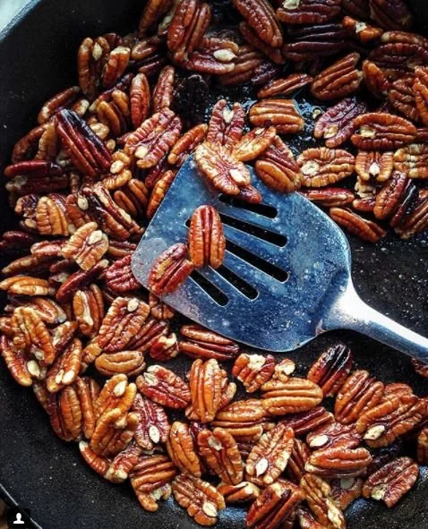 Toasted pecans in a cast iron pan