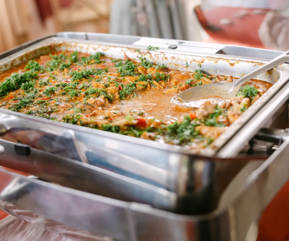 A guest serving herbed rice from the wedding buffet