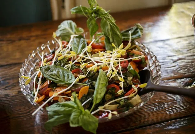 A basil-topped salad in a glass bowl