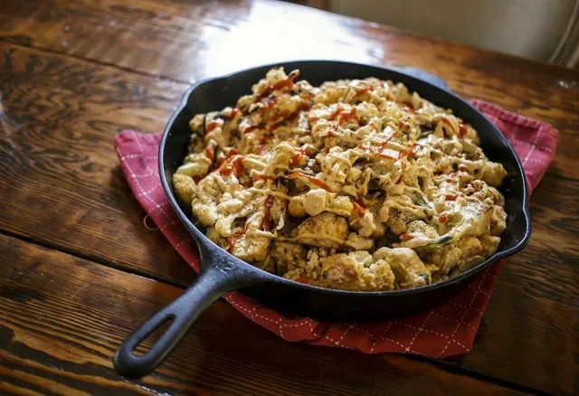 A cast iron skillet of baked eggs and vegetables