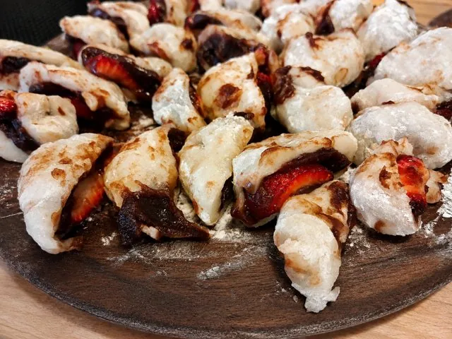 Strawberry mochi arranged on a wooden board