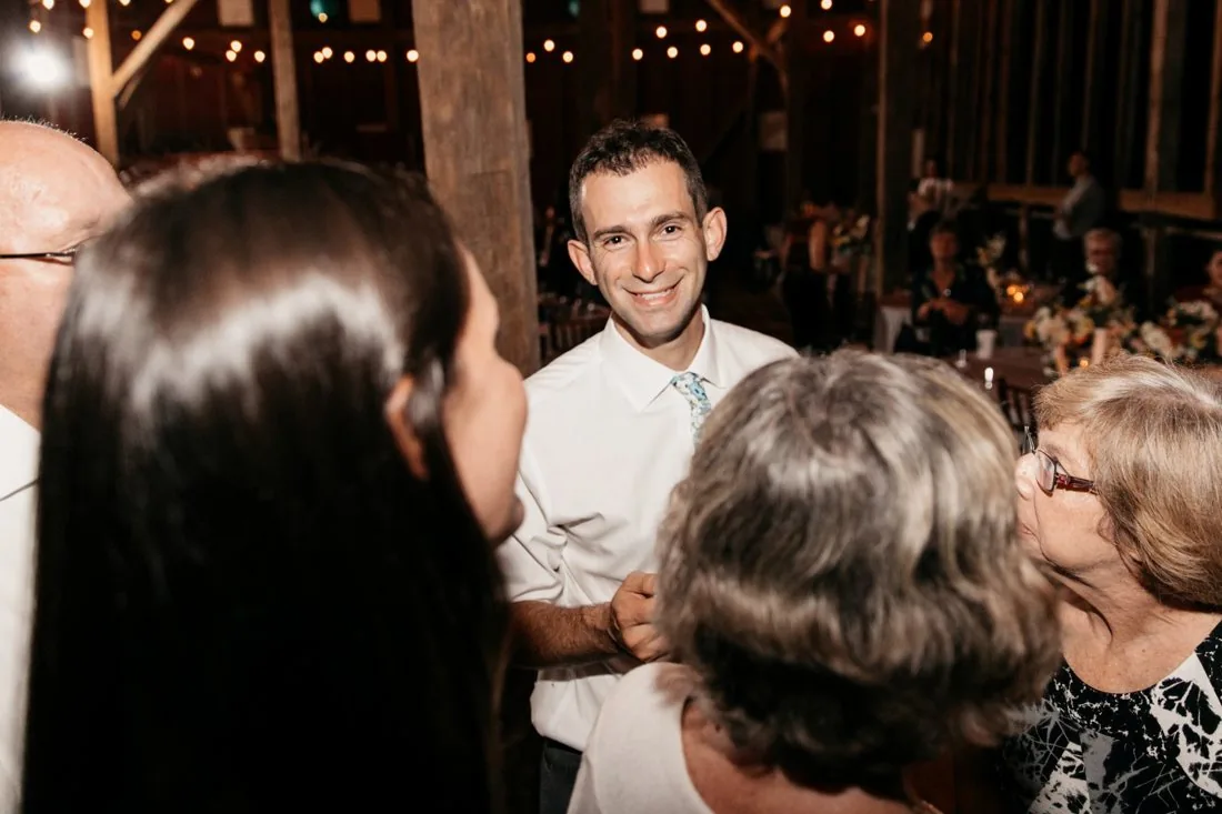 Josh in conversation with guests during a reception